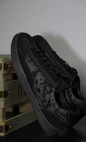 Black sneakers with textured pattern detail