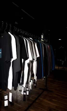 Minimal clothing rack in dark fashion store interior