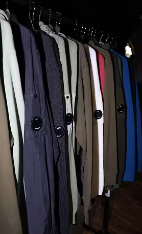 Clothing rack with neutral toned garments in store