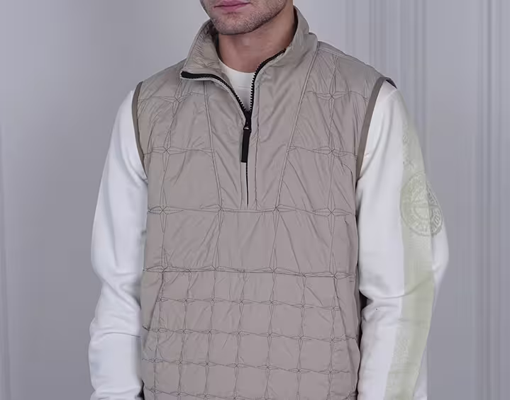 Close up of beige quilted vest in minimalist streetwear style