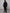 Man wearing black techwear hooded jacket with goggles in urban style