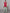 Man wearing red puffer vest with light green outfit in streetwear style